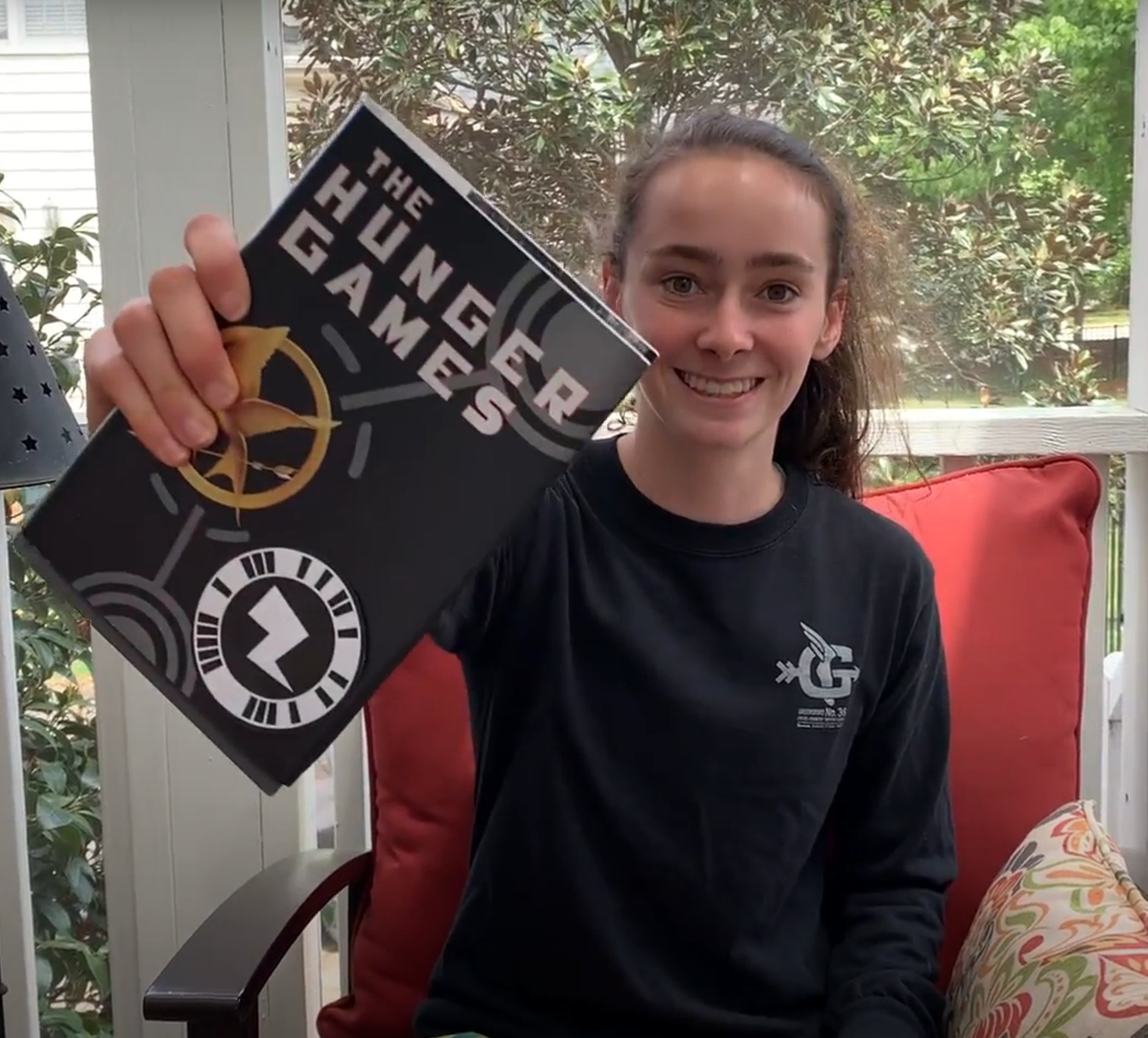 Girl holding up Hunger Games book with ZappAR code attached